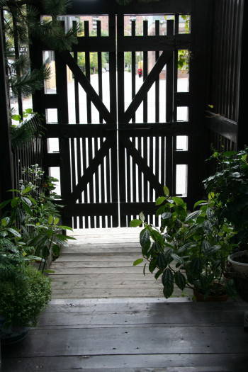 The entrance gate with its primitive self-closing mechanism.